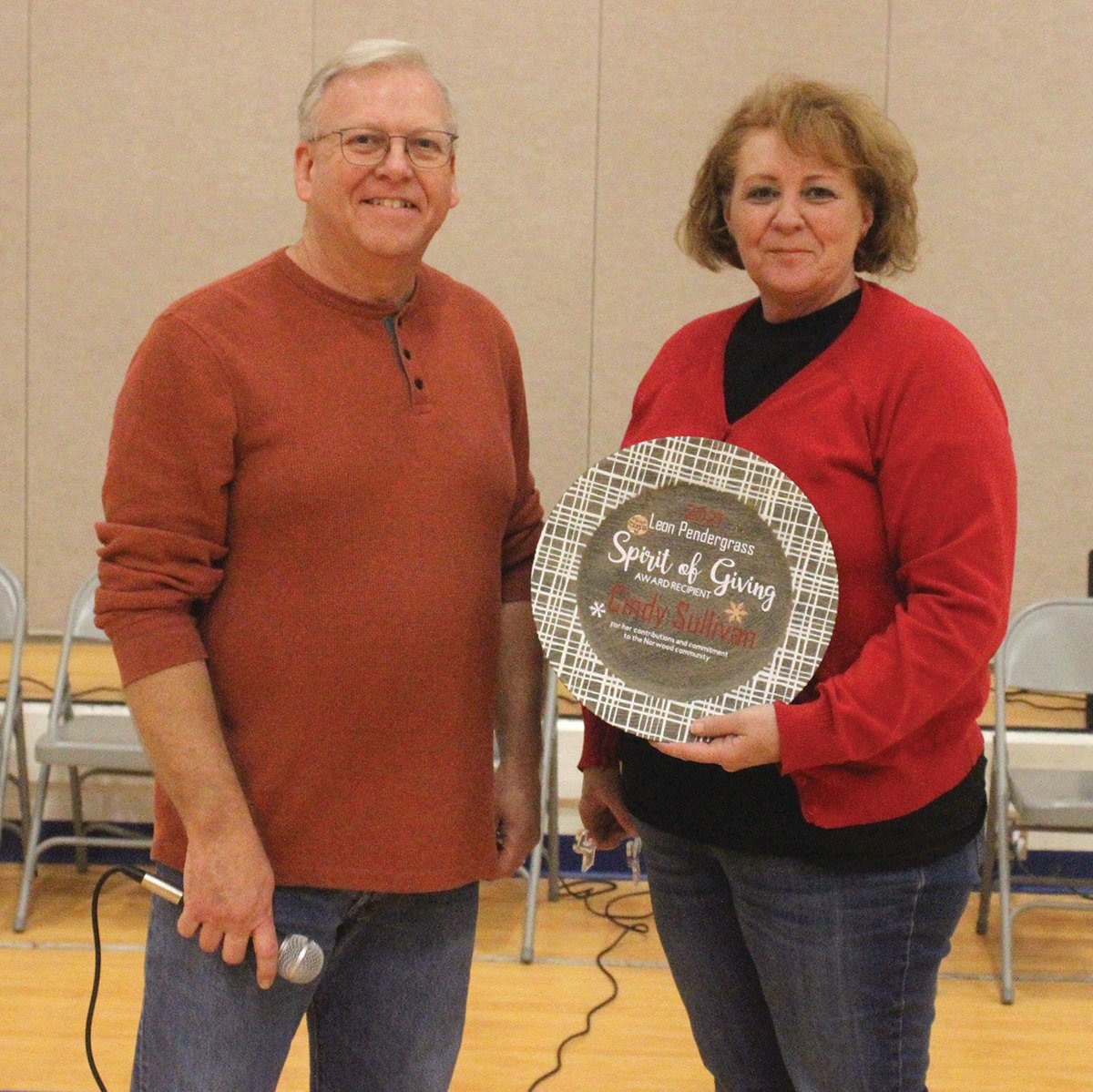 Rick Bruffett, left, presented his sister, Cindy Sullivan, with the Leon Pendergrass Spirit of Giving Award.